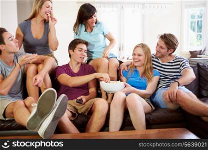 Group Of Friends Relaxing On Sofa At Home Together