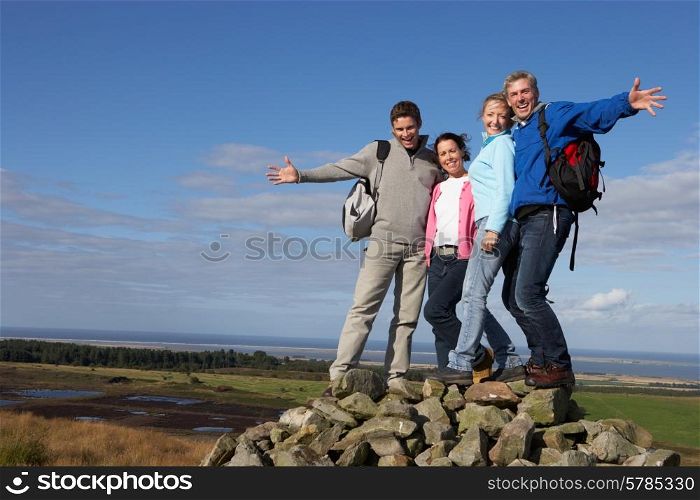 Group Of Friends Resting On Countryside Walk