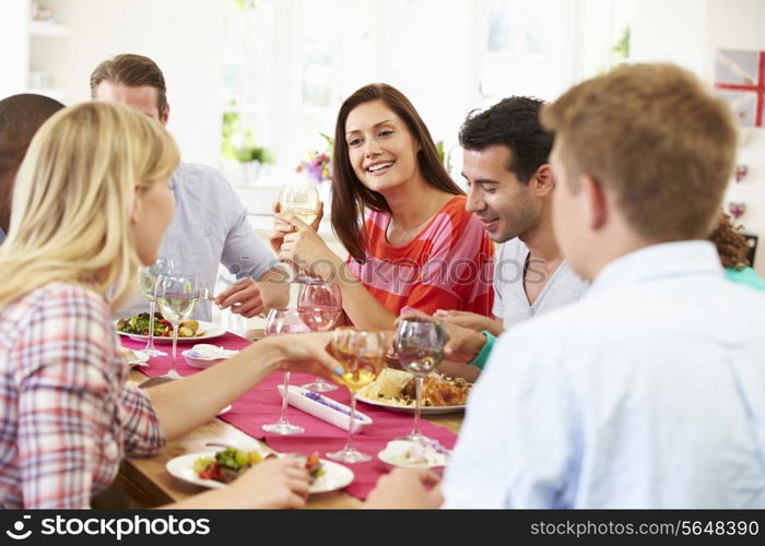 Group Of Friends Sitting Around Table Having Dinner Party