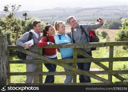 Group Of Friends Taking Photograph On Country Walk