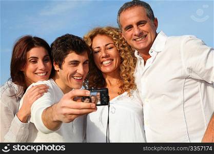 Group of friends taking picture of themselves at the beach