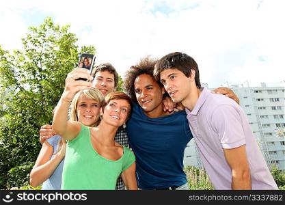 Group of friends taking picture with mobile phone