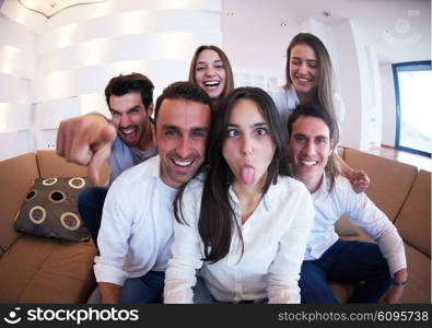 group of friends taking selfie photo with tablet at modern home indoors