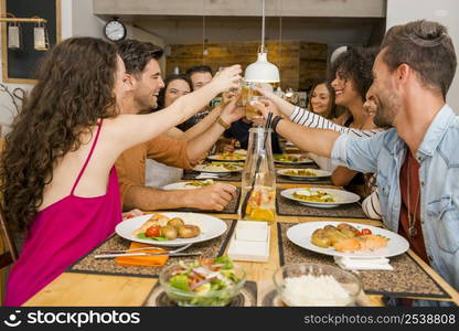 Group of friends toasting and having a good time at the restaurant