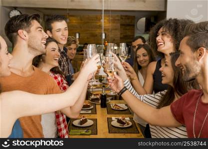 Group of friends toasting and looking happy at a restaurant