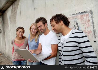 Group of friends using a laptop