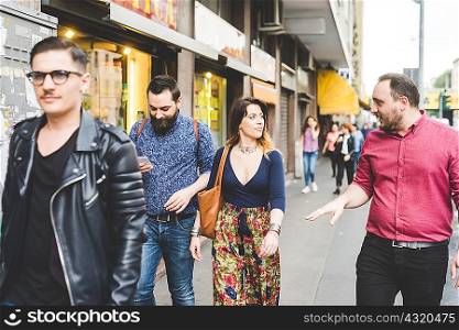 Group of friends walking on sidewalk