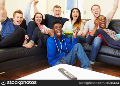 Group Of Friends Watching Television At Home Together
