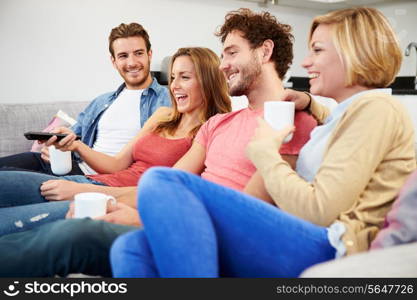 Group Of Friends Watching Television Together At Home