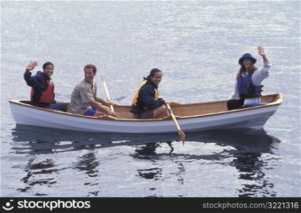 Group Of Friends Waving From A Canoe