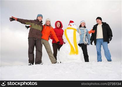 group of friends with snowman