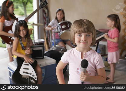 Group of girls (7-9) with instruments in garage