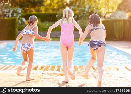 Group Of Girls Jumping Into Outdoor Swimming Pool