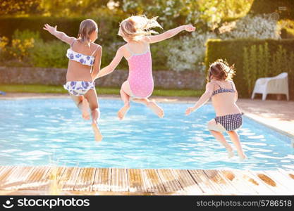 Group Of Girls Jumping Into Outdoor Swimming Pool