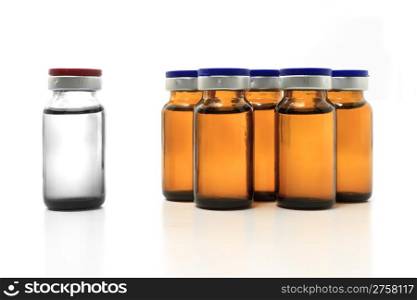 group of glass yellow bottles and a white one on white background