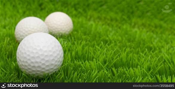 Group of Golf Balls in Green Grass