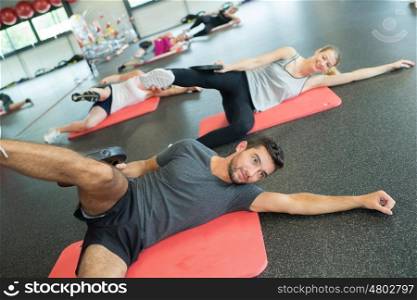 group of gym people at a stretching class