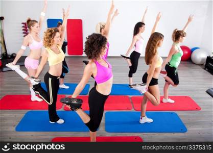 Group of gym people in a stretching class.