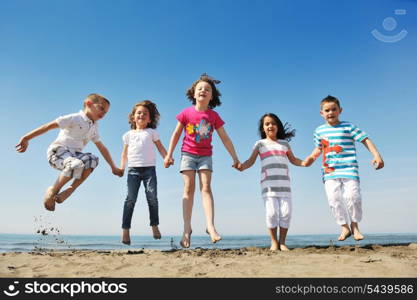 group of happy child on beach who have fun and play games