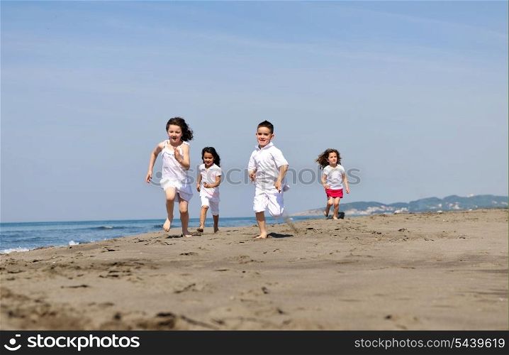 group of happy child on beach who have fun and play games