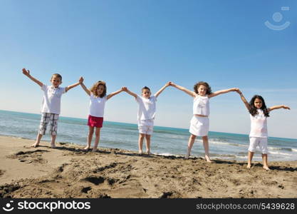 group of happy child on beach who have fun and play games