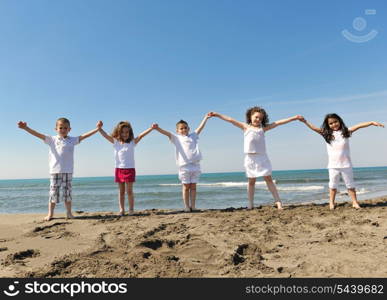 group of happy child on beach who have fun and play games