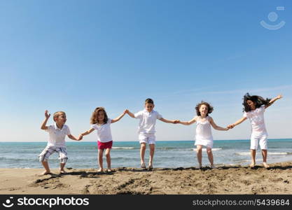 group of happy child on beach who have fun and play games