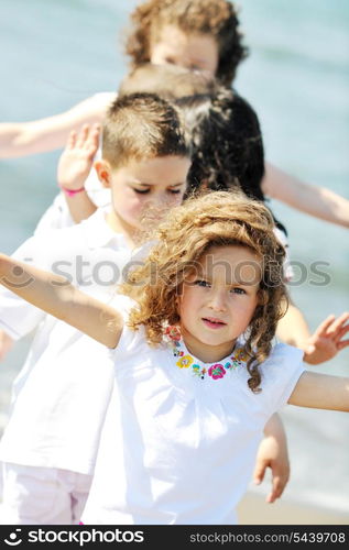 group of happy child on beach who have fun and play games