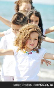 group of happy child on beach who have fun and play games