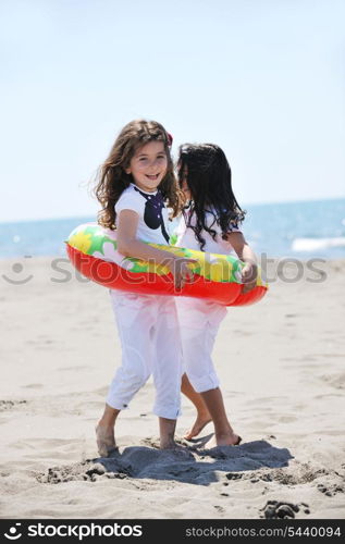 group of happy child on beach who have fun and play games