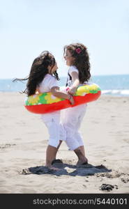 group of happy child on beach who have fun and play games