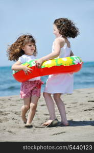 group of happy child on beach who have fun and play games