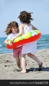 group of happy child on beach who have fun and play games