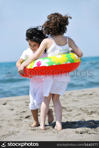 group of happy child on beach who have fun and play games