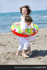 group of happy child on beach who have fun and play games