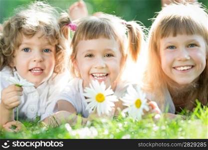 Group of happy children playing outdoors in spring park