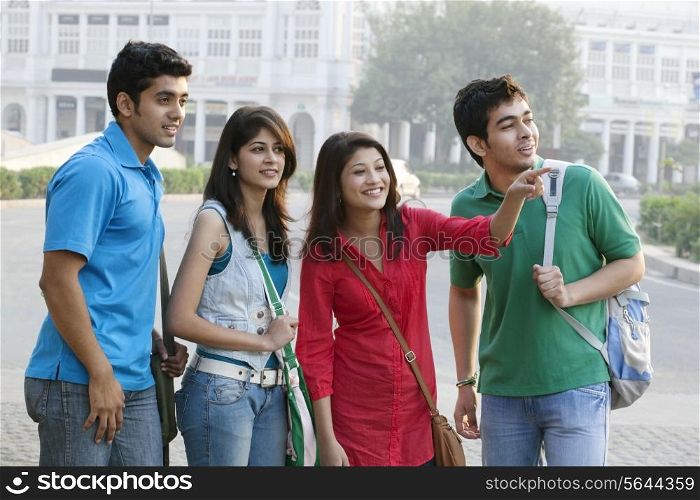 Group of happy college friends looking away