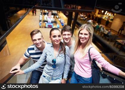 group of happy friends in shopping mall have fun
