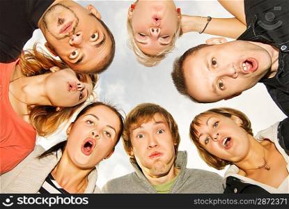 Group of happy friends making surprised faces