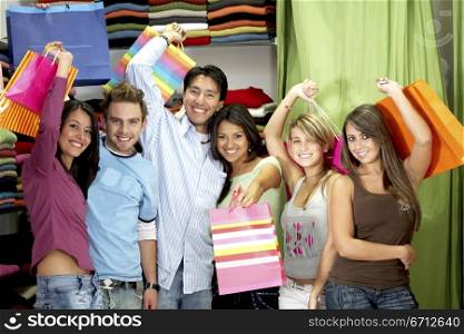 group of happy friends shopping at a retail store