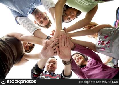 group of happy friends smiling with hands together