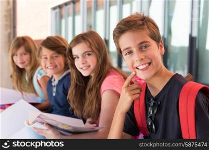 Group of happy little school kids in school