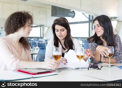 Group of happy students preparing their exams or simply relaxing at a bar