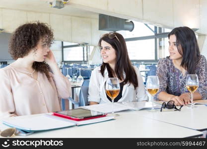 Group of happy students preparing their exams or simply relaxing at a bar