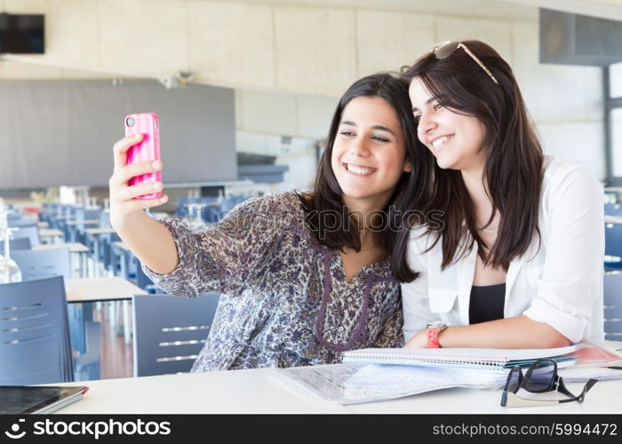 Group of happy students preparing their exams or simply relaxing at a bar