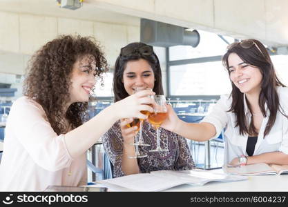 Group of happy students preparing their exams or simply relaxing at a bar