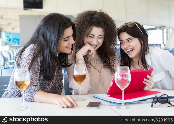 Group of happy students preparing their exams or simply relaxing at a bar