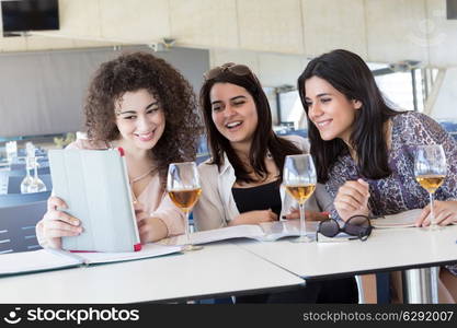 Group of happy students preparing their exams or simply relaxing at a bar