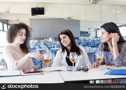 Group of happy students preparing their exams or simply relaxing at a bar