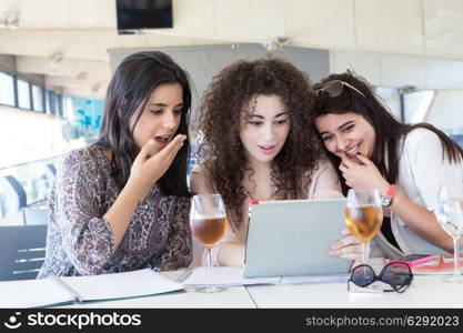 Group of happy students preparing their exams or simply relaxing at a bar